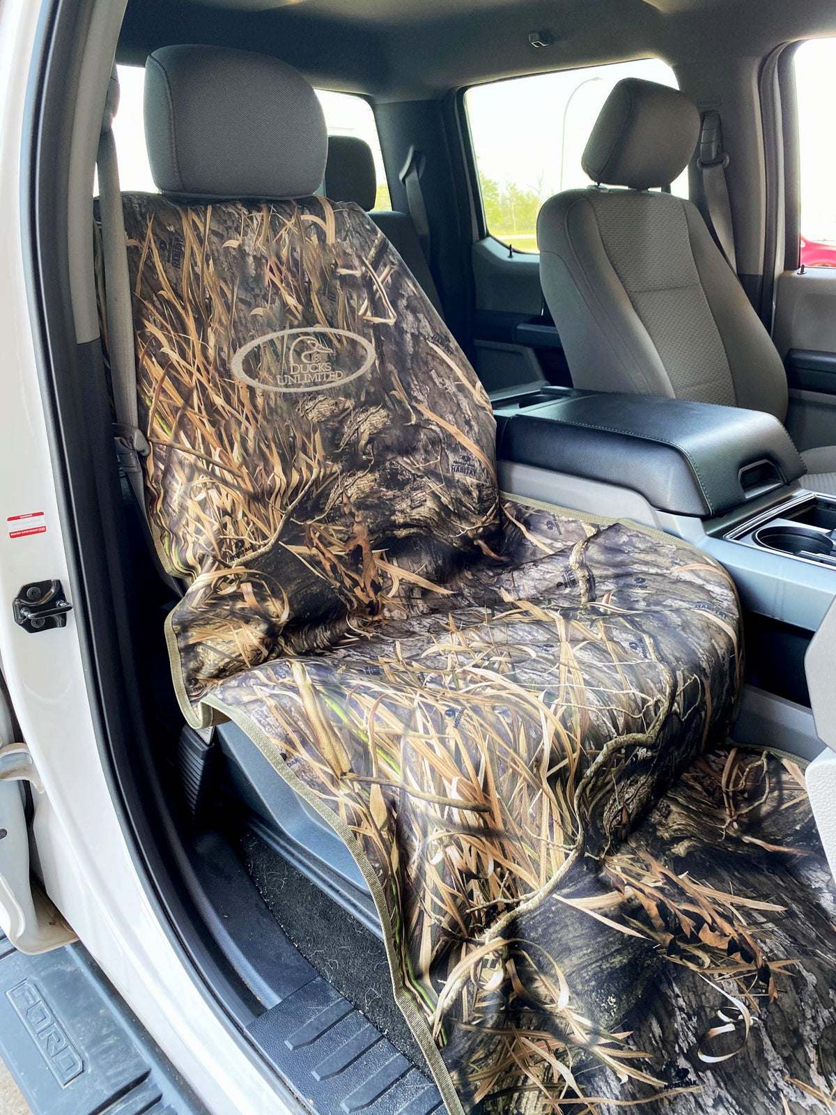 Camouflage-patterned car seat cover inside a vehicle